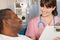 Nurse Talking To Senior Male Patient On Ward