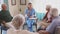 Nurse talking to senior people during group therapy