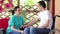 Nurse talking with young man in wheelchair