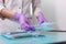 A nurse in a uniform and medical mask lays out sterile dental instruments Packed in a Kraft bag. Photo without a face. Gloved hand