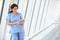 Nurse Using Digital Tablet In Corridor Of Modern Hospital