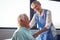 Nurse using stethoscope to take care of a senior man