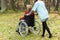 Nurse walking with disabled lady