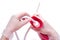 Nurse wearing sterile rubber gloves holds Cleansing Enema Bucket Set on white background. Enema Mug