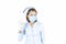 Nurse in white medical gown, sterile face mask showing OK gesture.