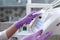 A nurse wipes the dental unit. Gloved hand. Unrecognizable photo. Disinfection in the dental office. Copy of the space. Gray