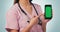 Nurse, woman with phone and green screen, pointing in studio for telehealth, online healthcare and expert advice