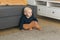 Nursery baby boy crawling on floor indoors at home copy space and empty space for text - Baby curiosity and child