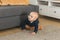 Nursery baby boy crawling on floor indoors at home copy space and empty space for text - Baby curiosity and child