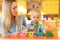 Nursery baby and carer play at table in daycare centre