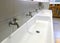 Nursery bathroom interior with low white ceramic sinks and taps