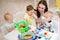 Nursery children playing with teacher in kindergarten