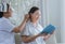 Nurses combing hair for elderly to Care and elderly read book. Caregiver with elderly of kindness concept