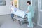 Nurses moving patient through hospital hallway