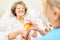 Nursing assistance gives sick elderly pills