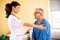 Nursing home doctor providing care to a senior man resident