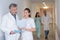 Nursing staff looking at paperwork in hospital corridor