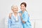 Nursing wife and happy elderly woman