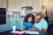 Nurturing a creative spirit. a cute little girl and her father painting together at the kitchen table.