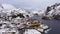 Nusfjord Fishing Village and Mountains in Winter. Lofoten Islands, Norway. Aerial View