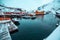 Nusfjord, small fishing village in Norway, during amazing winter evening, ships, snow and yellow cabins.