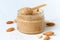 Nut butter, crunchy and stir, white wooden table, glass jar, side view, close up