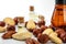 Nut oil bottles and variety of nuts on white