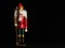 NUTCRACKER DOLL ON BLACK BACKGROUND WITH GREEN PATALON AND RED JACKET