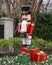 Nutcracker standing guard protecting a house in Dallas, Texas, with gifts at his feet.