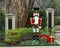 Nutcracker standing guard protecting a house in Dallas, Texas, with gifts at his feet.