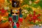 A nutcracker stands on  guard in front of  a  decorated Christmas tree
