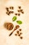 Nutmeg - ground indian condiment in spoon - on beige background top-down