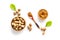 Nutmeg - ground indian condiment in spoon - on white background top-down