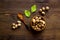 Nutmeg - ground indian condiment in spoon - on wooden background top-down