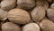 Nutmeg whole background. Natural seasoning texture. Natural spices and food ingredients