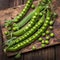 Nutrient rich display Fresh bio peas and pods on an oak board