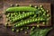 Nutrient rich display Fresh bio peas and pods on an oak board