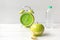 Nutrition start up workout plan. Close up green apple with measuring tape.