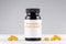Nutritional supplement turmeric curcumin bottle and capsules on gray