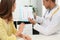 Nutritionist consulting patient at table in clinic