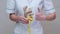 Nutritionist doctor healthy lifestyle concept - holding ginger root and measuring tape