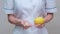 Nutritionist doctor healthy lifestyle concept - holding lemon fruit and medicine or vitamin pills