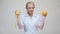 Nutritionist doctor healthy lifestyle concept - holding orange fruit