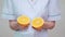 Nutritionist doctor healthy lifestyle concept - holding orange fruit