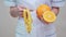 Nutritionist doctor healthy lifestyle concept - holding orange fruit