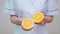 Nutritionist doctor healthy lifestyle concept - holding orange fruit
