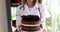 Nutritionist doctor holding chocolate sweet cake