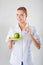 Nutritionist female Doctor holding a green apple