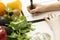 Nutritionist woman writing diet plan on table full of fruits and
