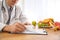 Nutritionist working at desk in office, closeup